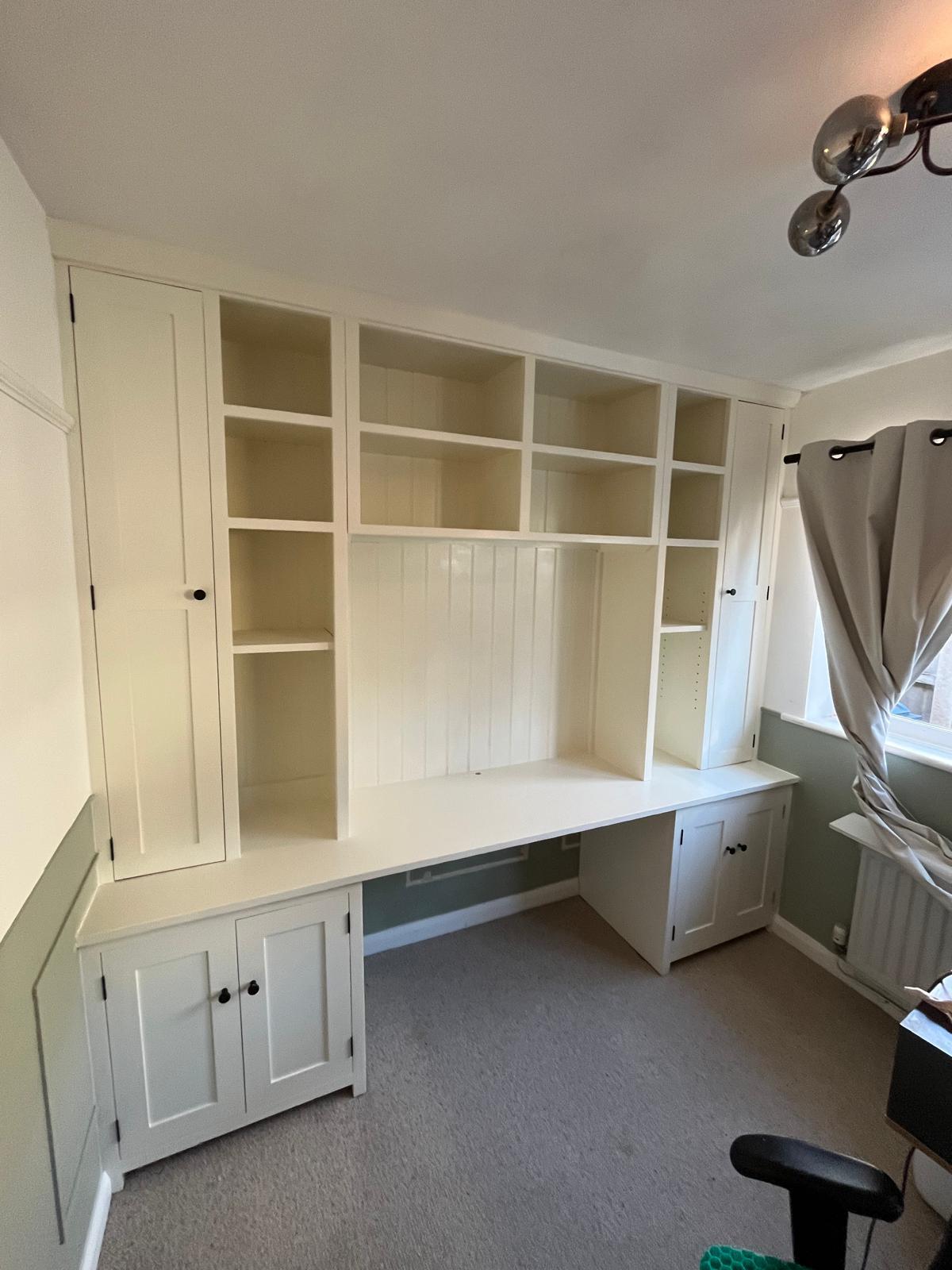 White fitted home office with a desk, cupboards and open shelves