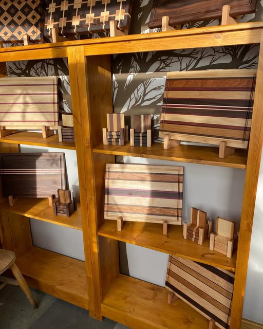 Striped wooden boards displayed on workshop shelves